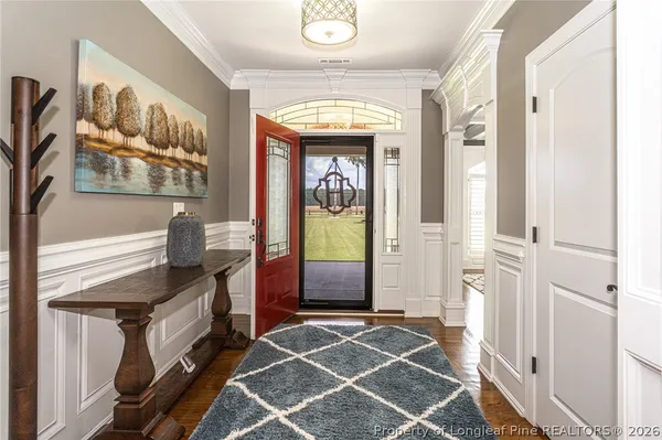 a kitchen with stainless steel appliances kitchen island granite countertop a table chairs sink refrigerator and cabinets