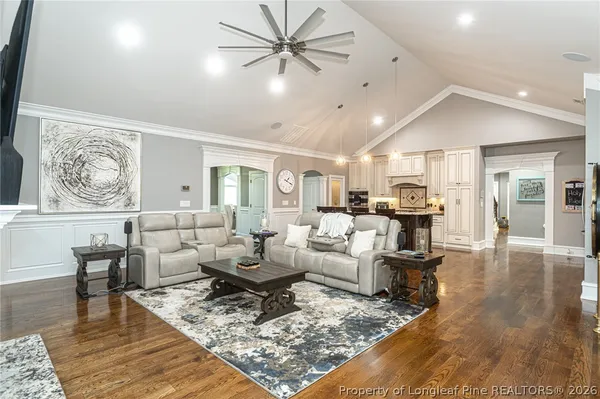 a kitchen with stainless steel appliances kitchen island granite countertop a dining table chairs and granite counter tops
