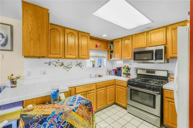 a kitchen with a sink appliances and cabinets
