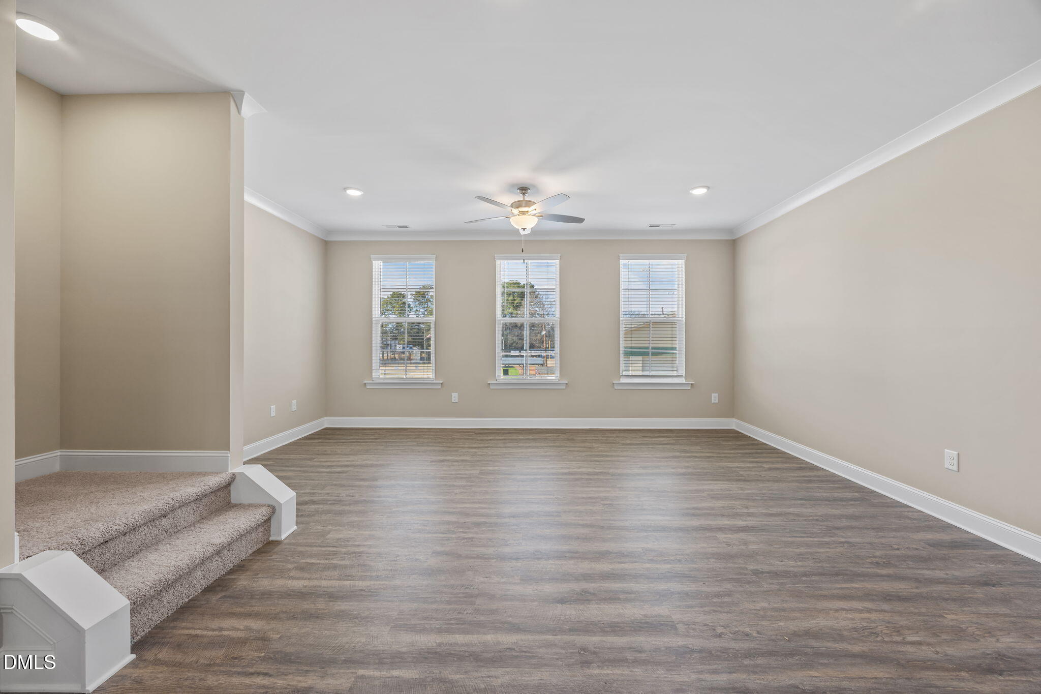 141 Pearl Street, Unit 9 Garner, NC 27529 - Photo 11 of 26 a view of an empty room with wooden floor and a window