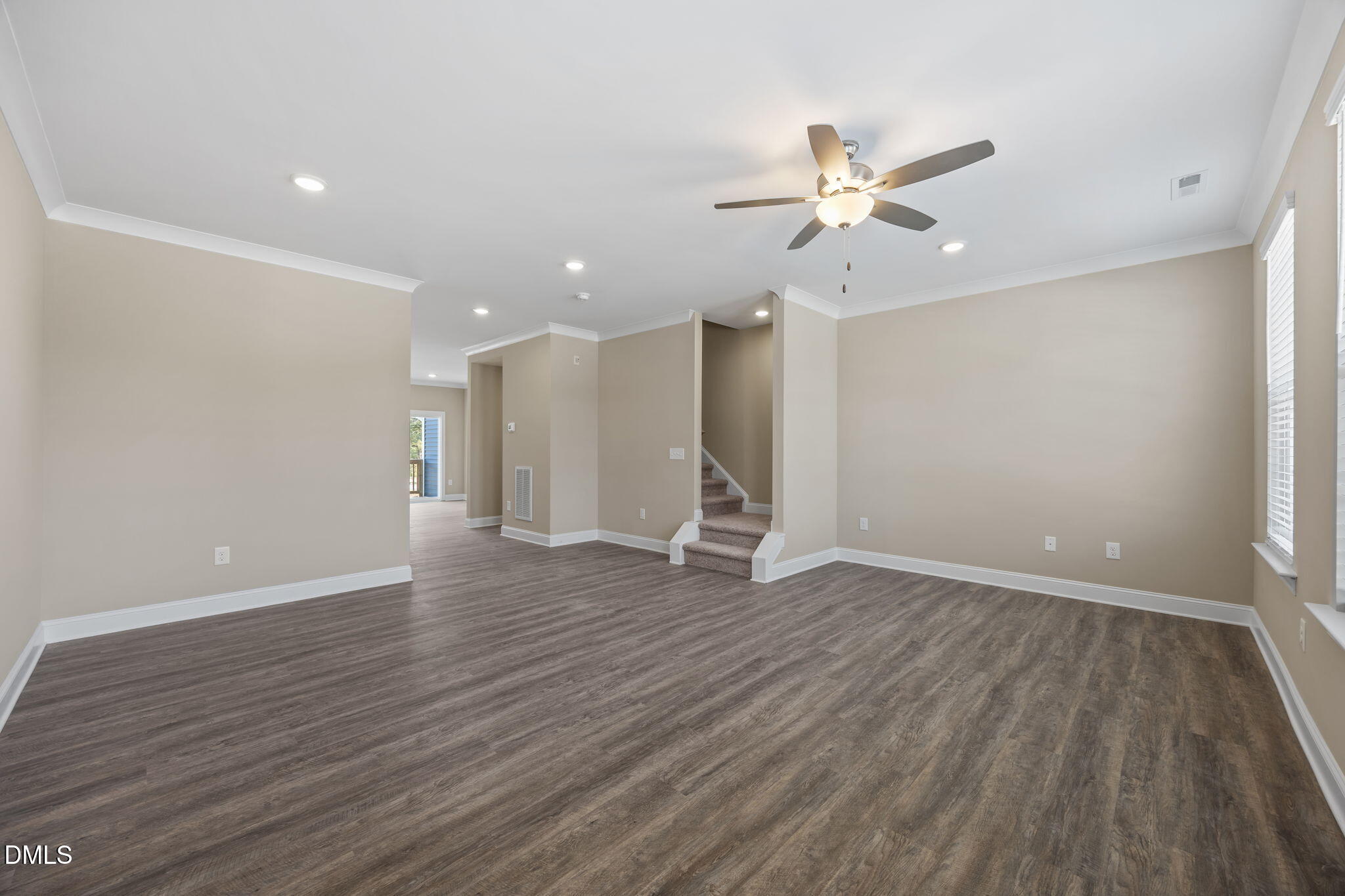 141 Pearl Street, Unit 9 Garner, NC 27529 - Photo 12 of 26 an empty room with wooden floor ceiling fan and window