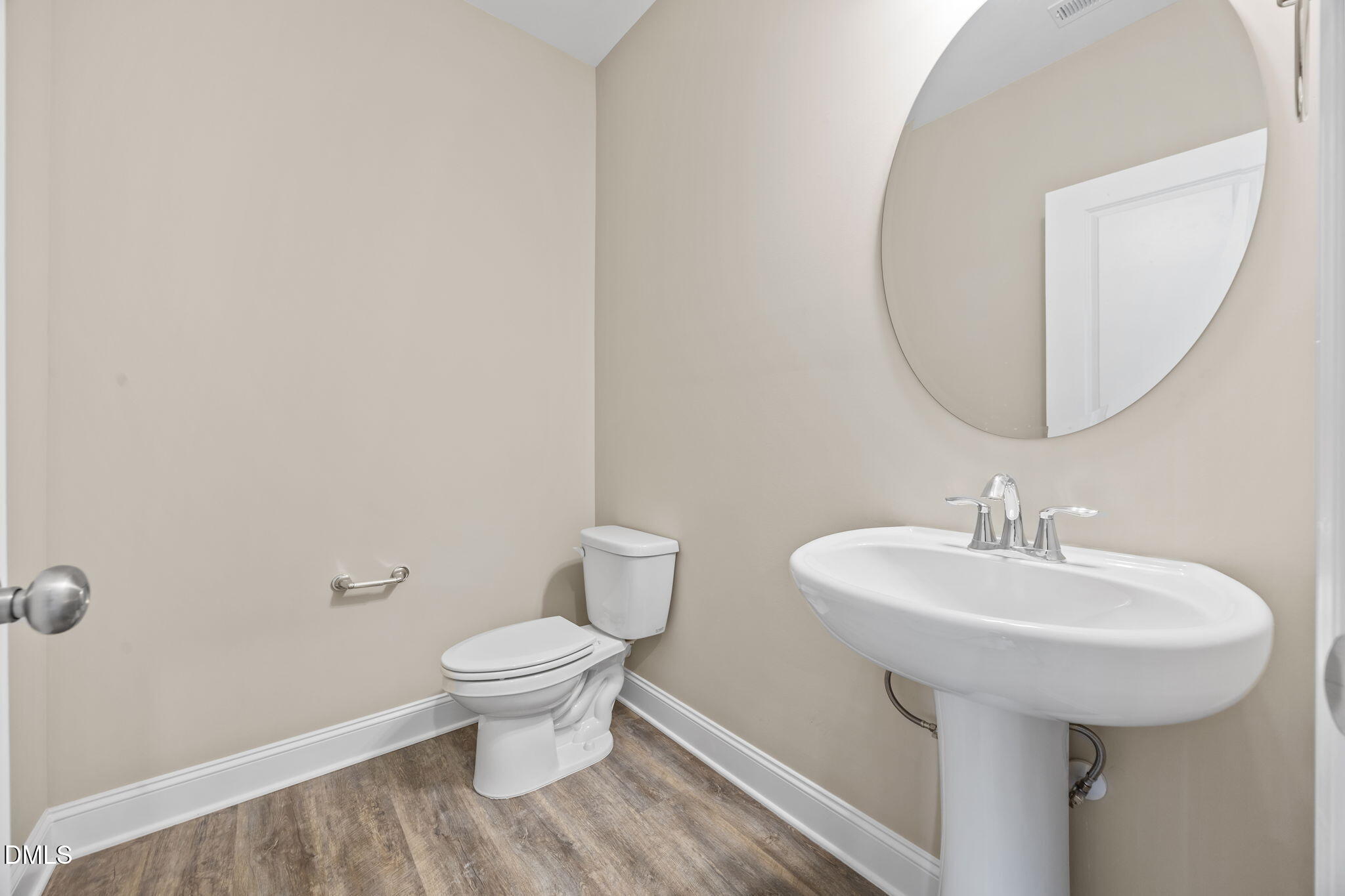 141 Pearl Street, Unit 9 Garner, NC 27529 - Photo 20 of 26 a bathroom with a sink toilet and a mirror