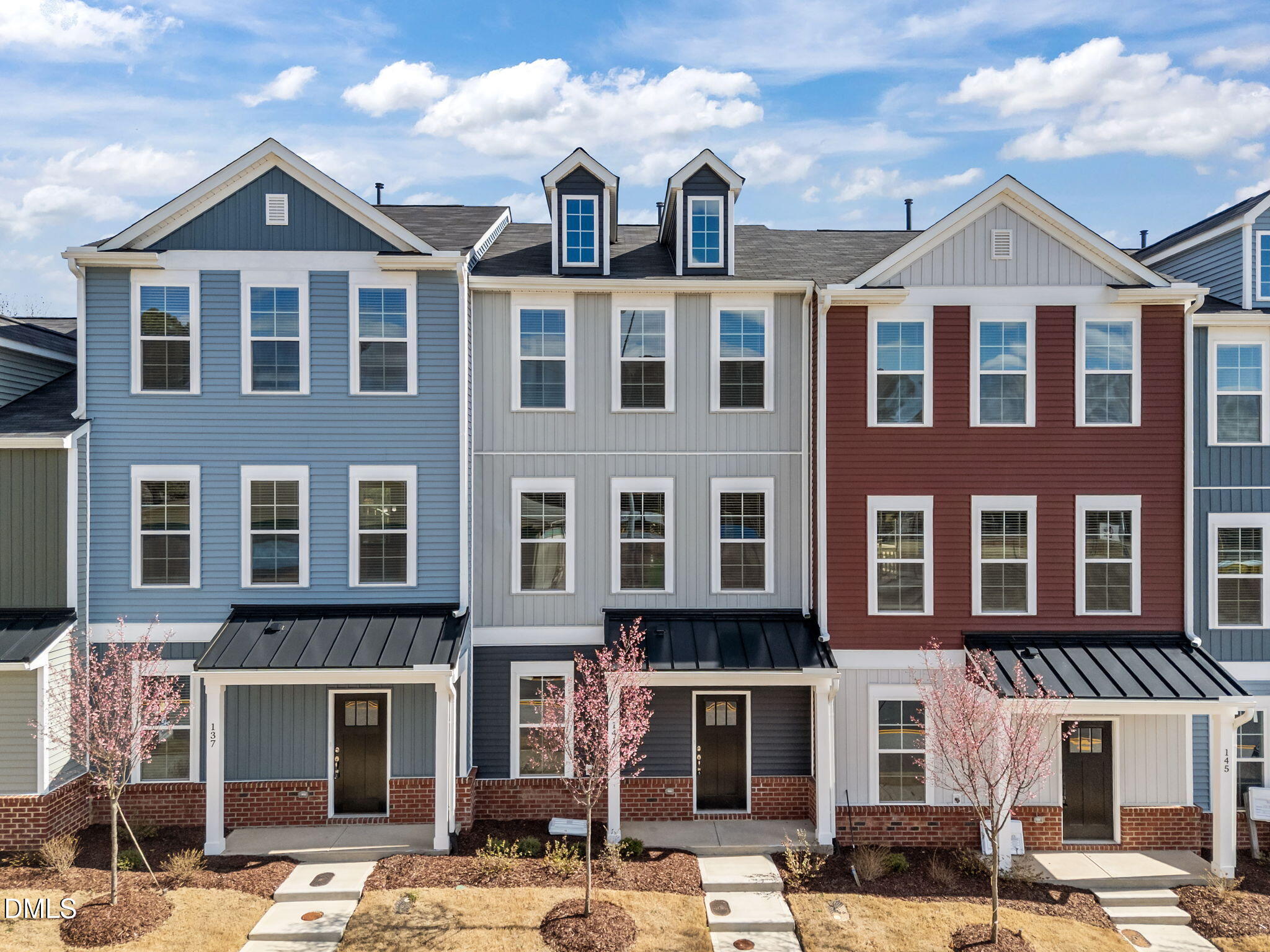 141 Pearl Street, Unit 9 Garner, NC 27529 - Photo 2 of 26 a front view of a building with lot of cars and trees