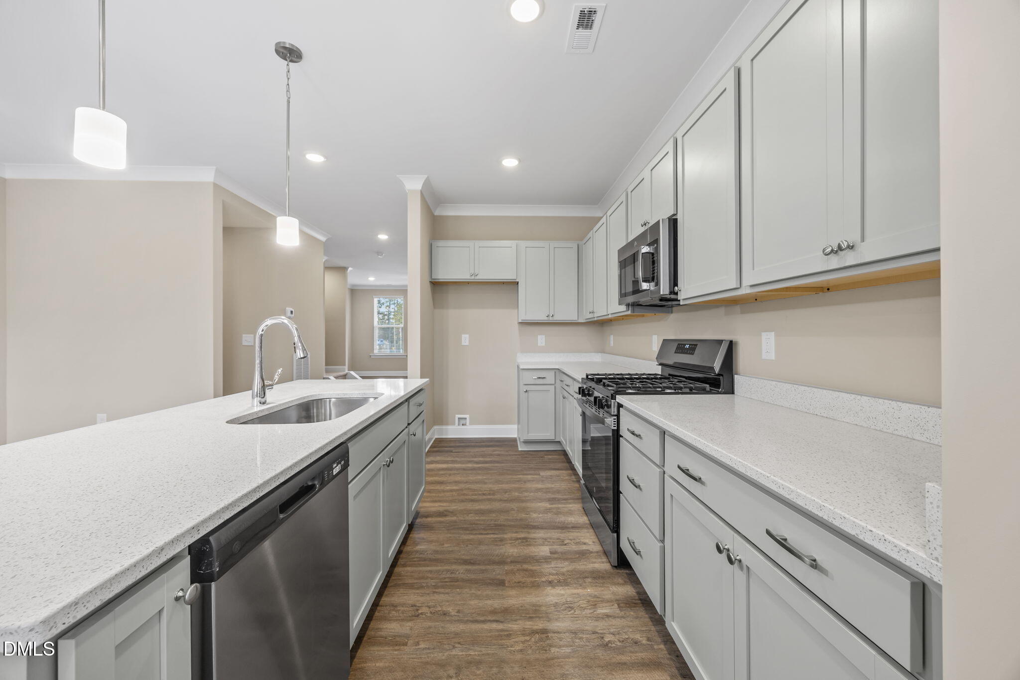 141 Pearl Street, Unit 9 Garner, NC 27529 - Photo 6 of 26 a kitchen with a sink stove and cabinets