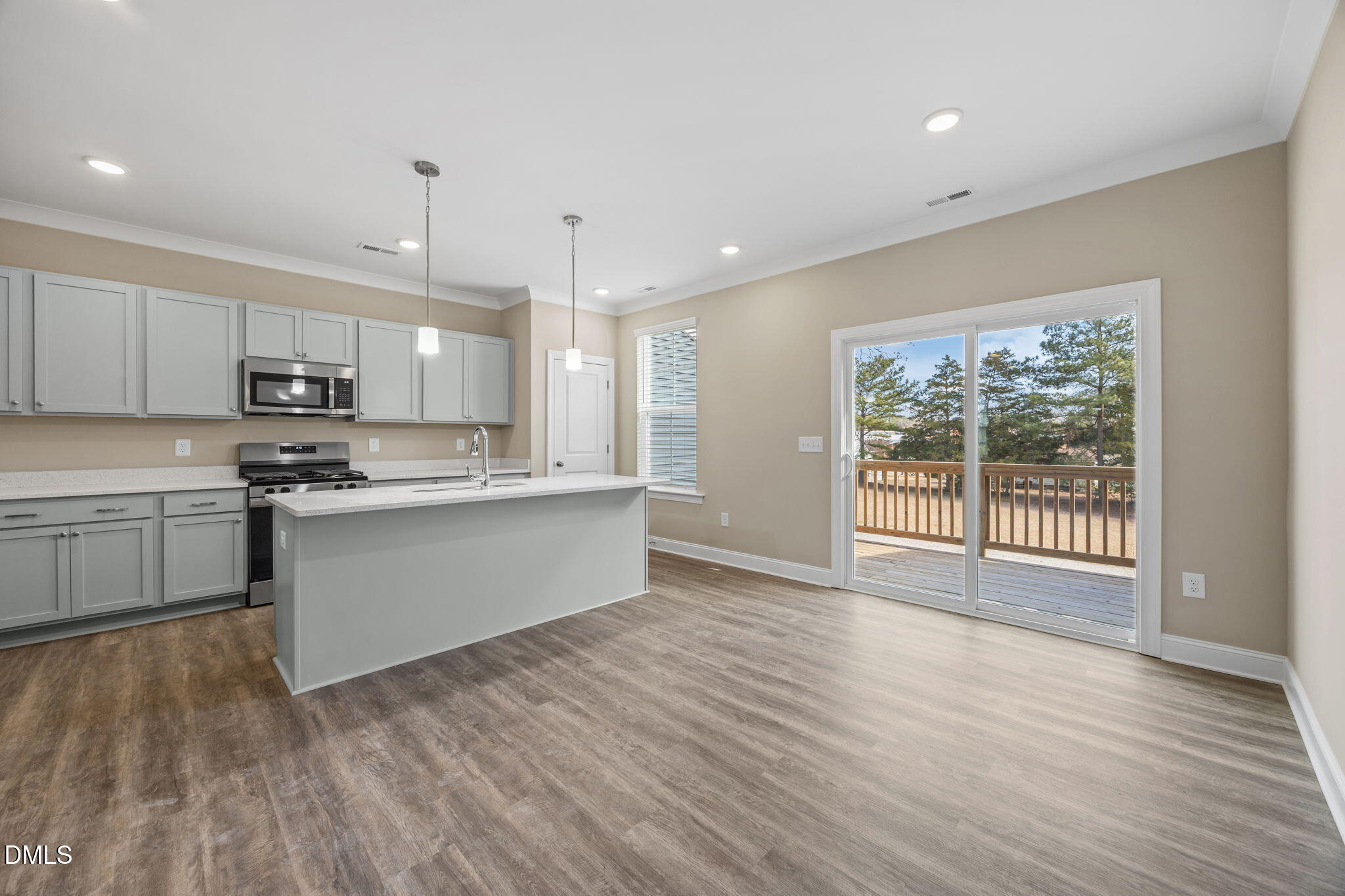 141 Pearl Street, Unit 9 Garner, NC 27529 - Photo 8 of 26 a large kitchen with stainless steel appliances granite countertop a stove a sink dishwasher a refrigerator white cabinets and wooden floor