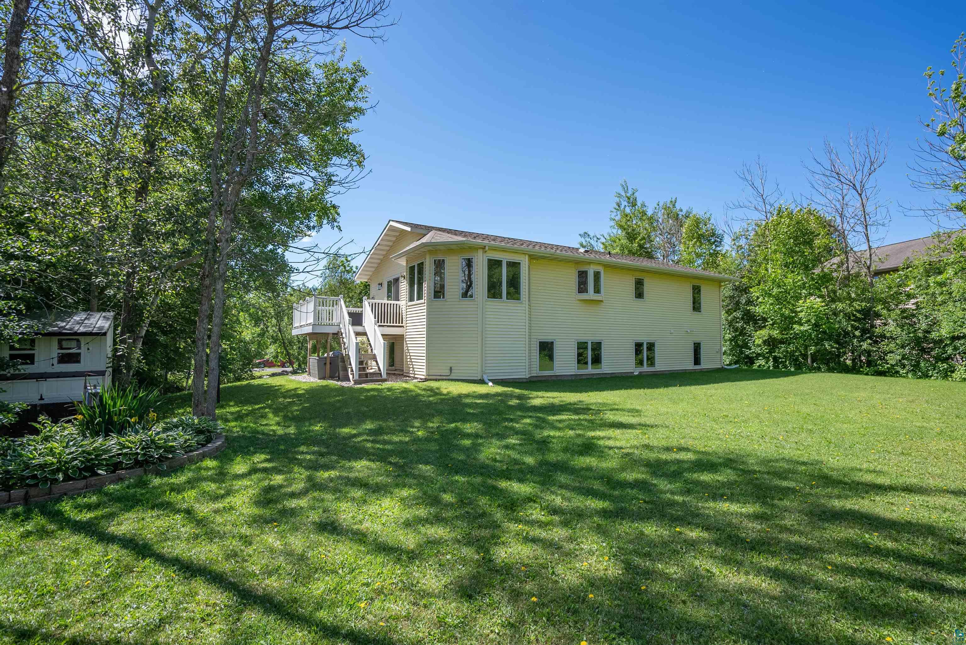 4809 Oak Ridge Drive Hermantown, MN 55811 - Photo 57 of 67 Expansive green lawn bordering a two-story residence with light-colored siding