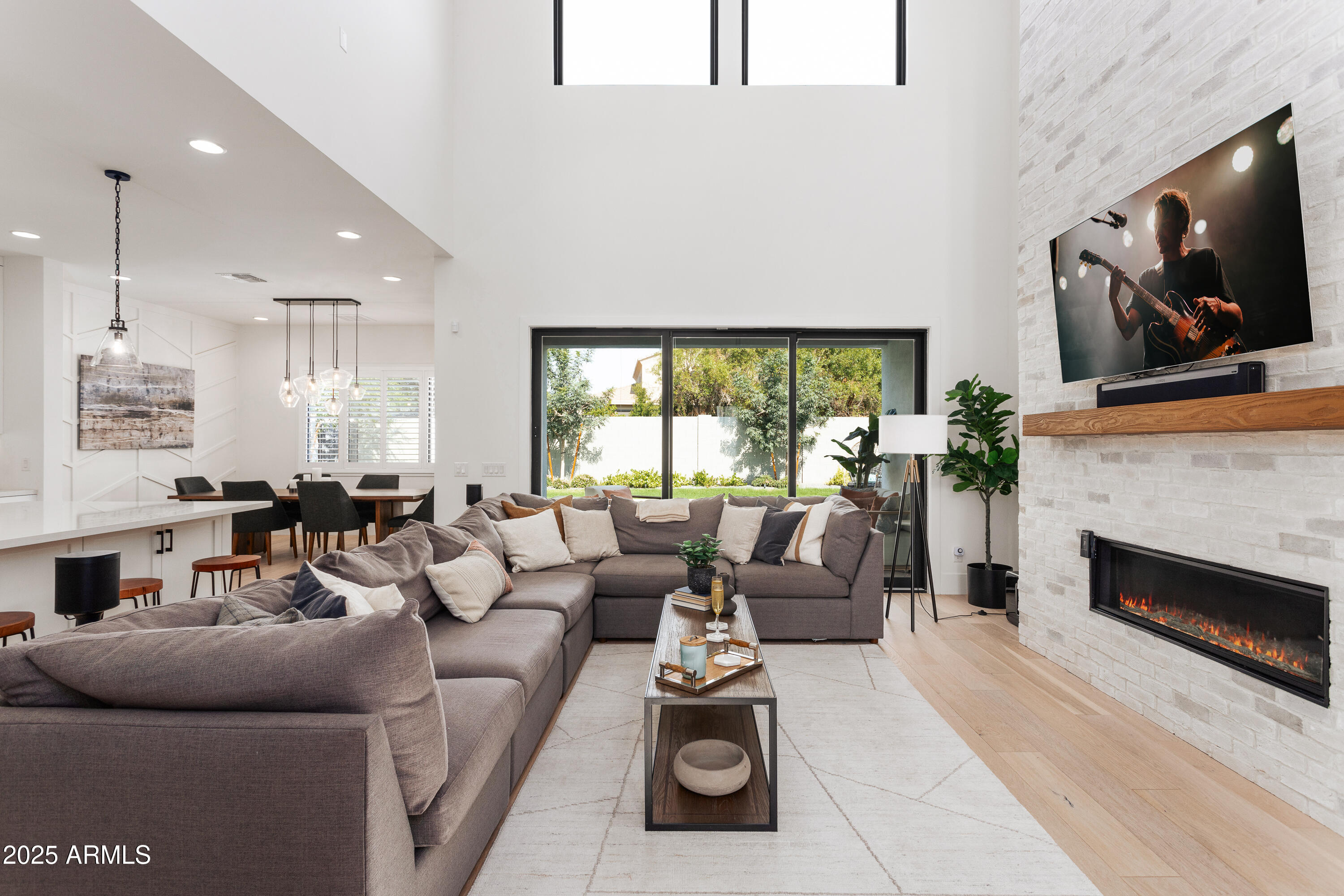 4007 North 34th Street Phoenix, AZ 85018 - Photo 11 of 43 a living room with furniture a fireplace and a flat screen tv