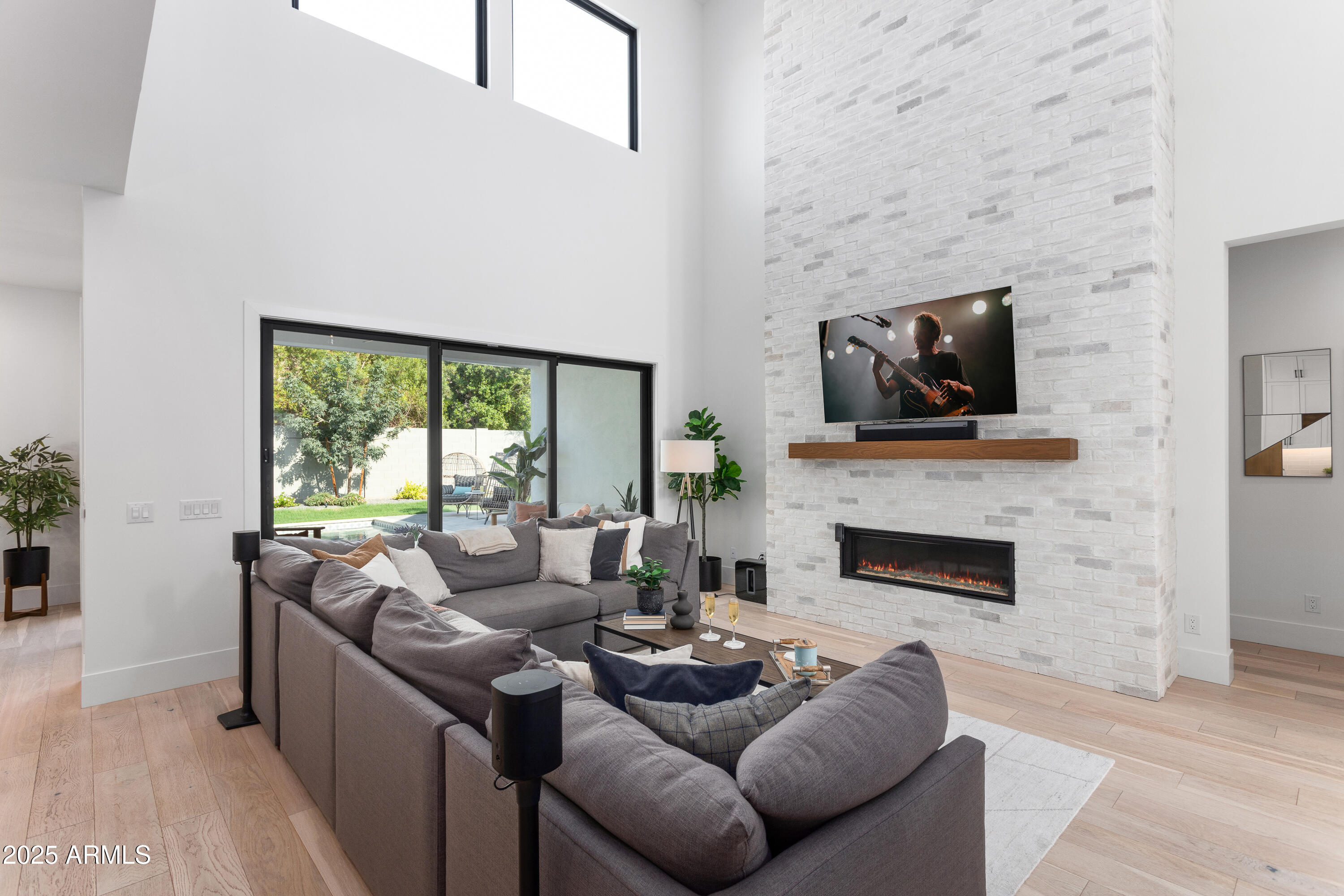 4007 North 34th Street Phoenix, AZ 85018 - Photo 12 of 43 a living room with furniture a flat screen tv and a fireplace