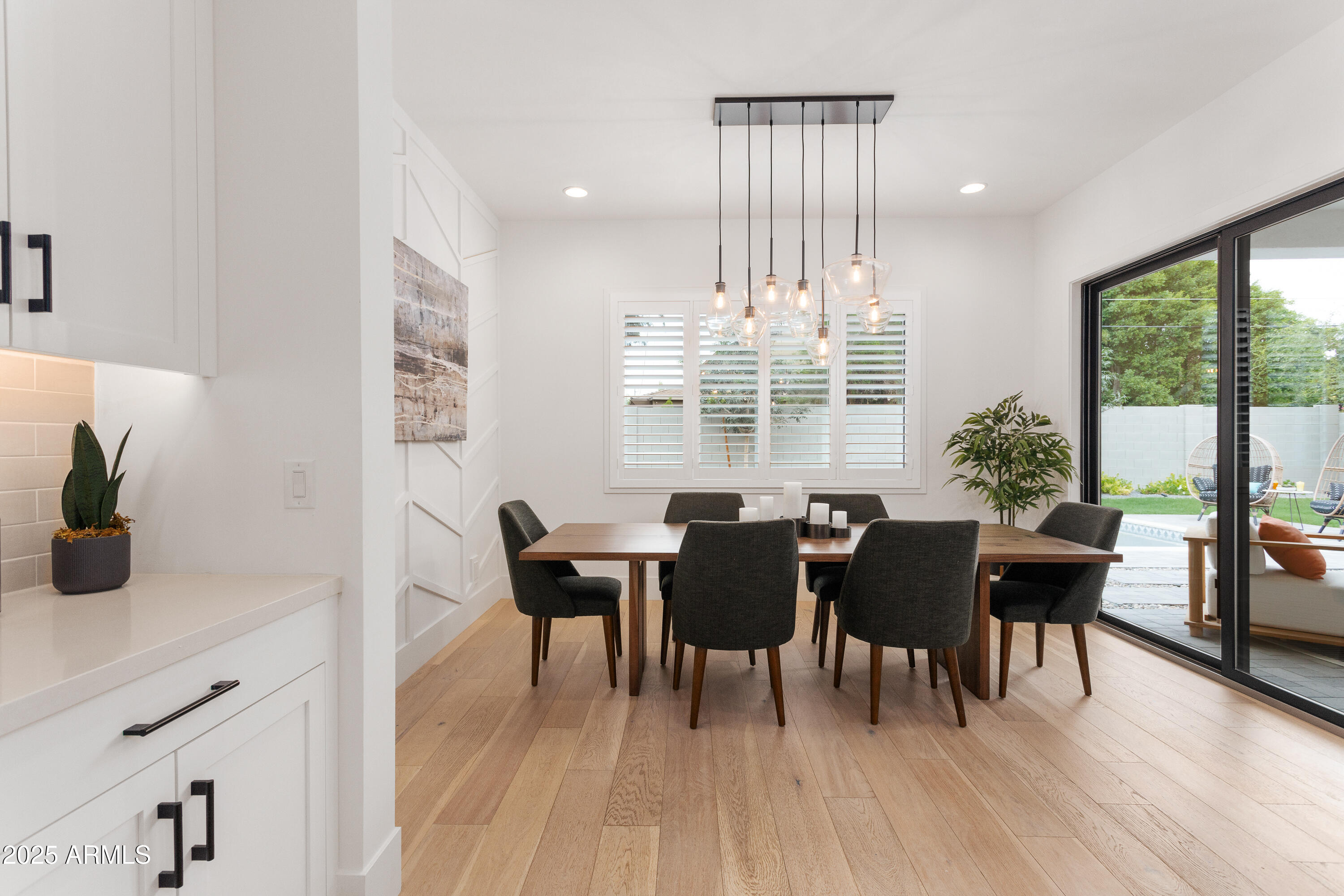 4007 North 34th Street Phoenix, AZ 85018 - Photo 18 of 43 a view of a dining room with furniture and wooden floor