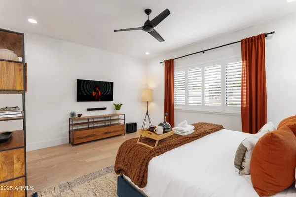 a bedroom with a bed and a flat screen tv