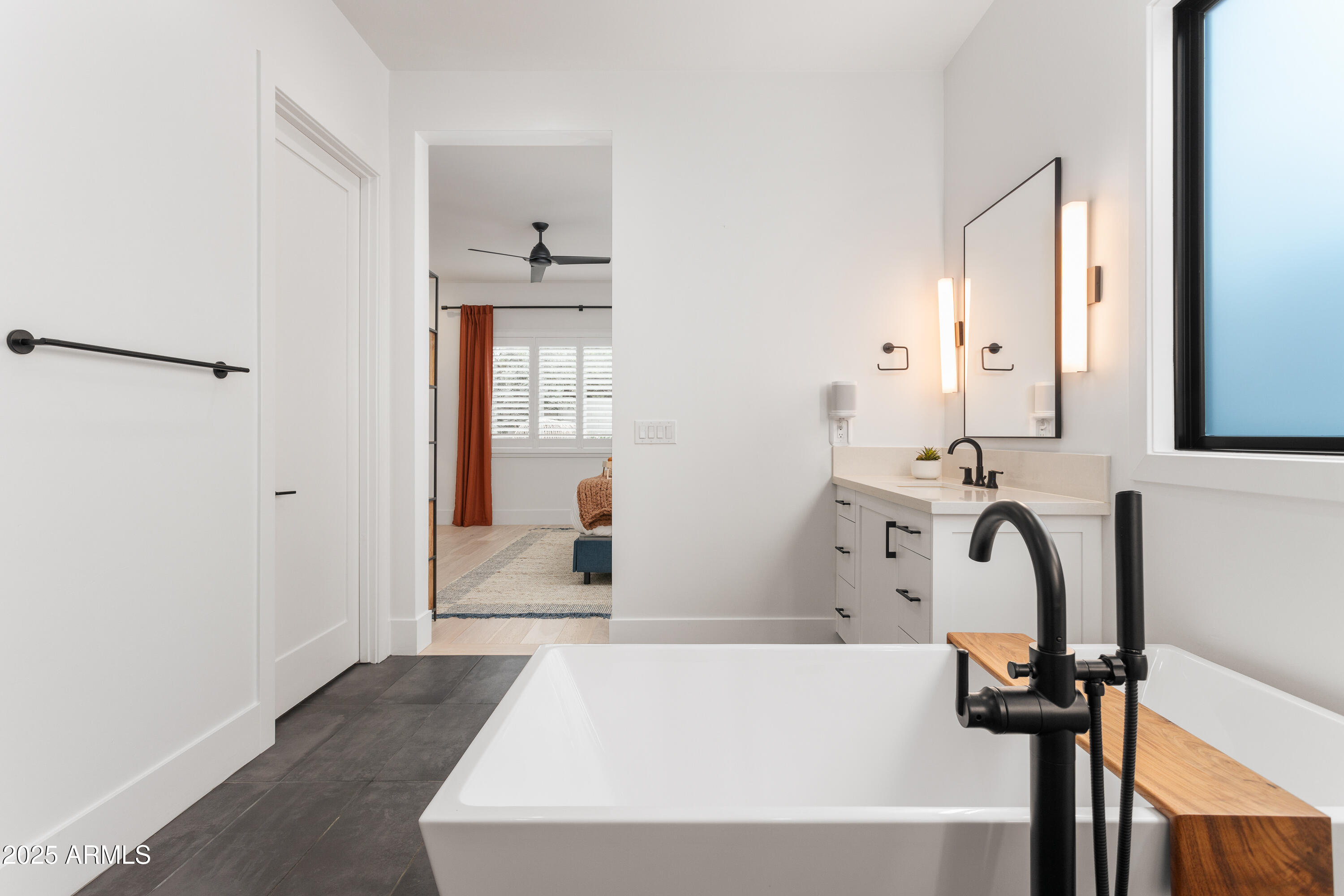4007 North 34th Street Phoenix, AZ 85018 - Photo 23 of 43 a bathroom with a bathtub sink and a mirror