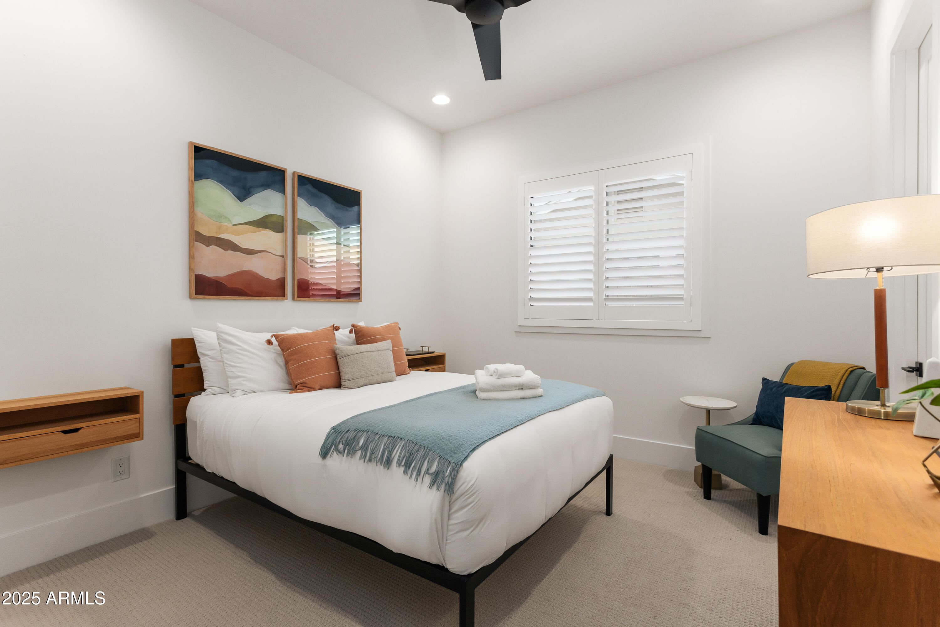 4007 North 34th Street Phoenix, AZ 85018 - Photo 26 of 43 a white bed sitting in a bedroom next to a lamp