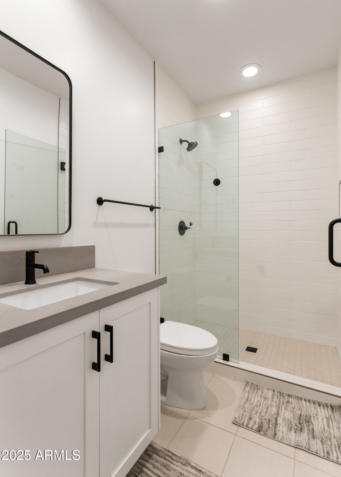 4007 North 34th Street Phoenix, AZ 85018 - Photo 28 of 43 a bathroom with a sink a toilet a mirror and shower