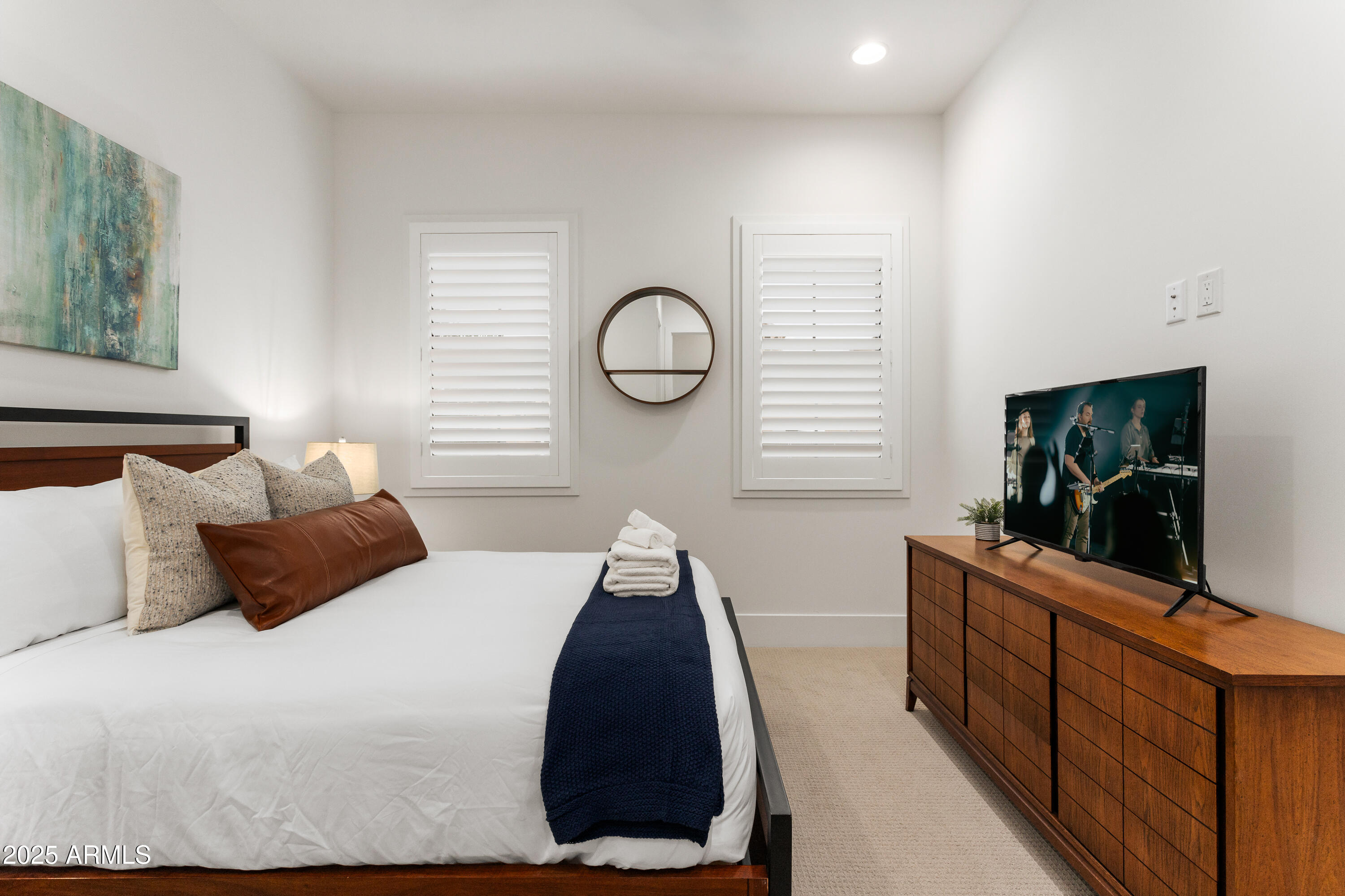 4007 North 34th Street Phoenix, AZ 85018 - Photo 31 of 43 a bedroom with a large bed and a flat tv screen on the dresser