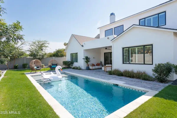 a view of a house with backyard and sitting area