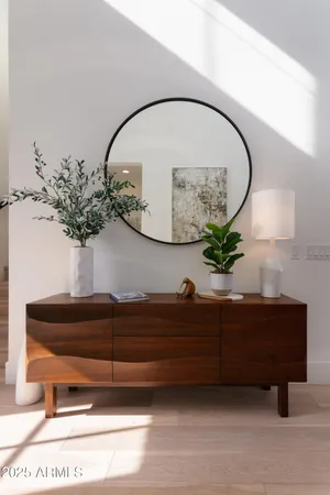 a living room with furniture and a mirror