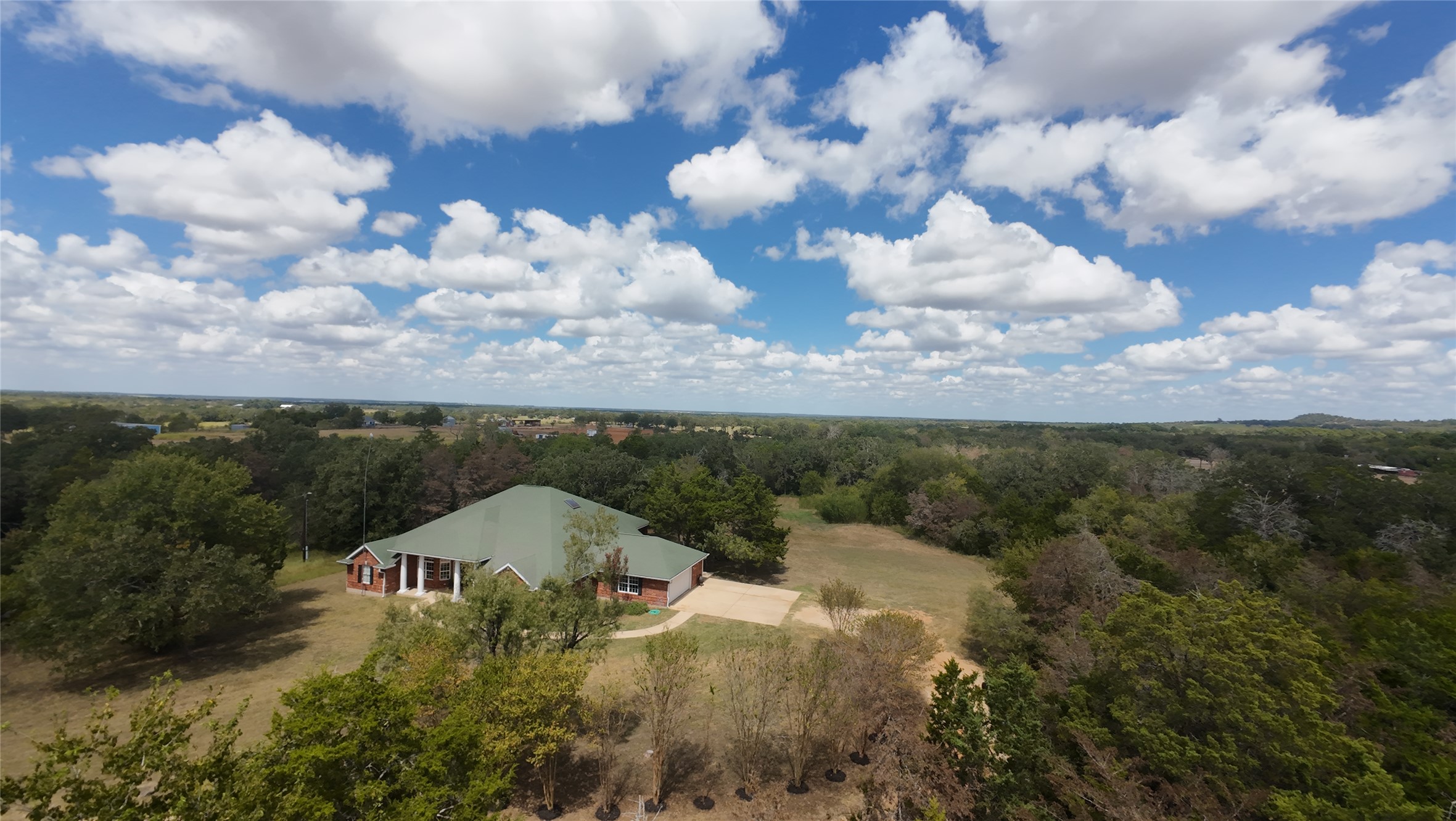 741 Knobbs Road McDade, TX 78650 - Photo 30 of 38 An aerial perspective reveals a secluded residence nestled amidst expansive natural surroundings, offering unparalleled tranquility.