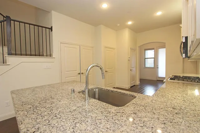 a view of a kitchen with a sink and cabinets