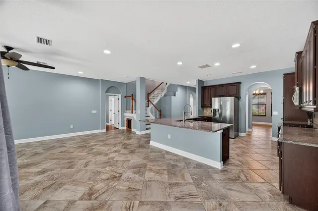 a large room with lots of counter space and windows