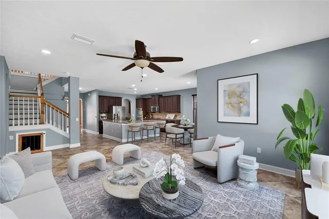 a living room with furniture a fireplace and a potted plant