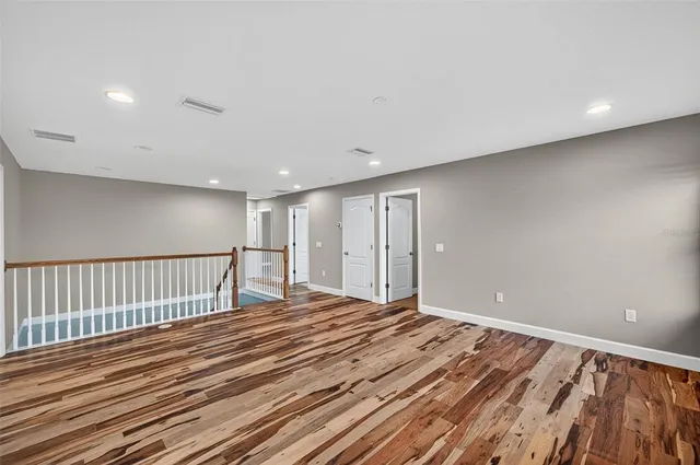 a view of a room with wooden floor