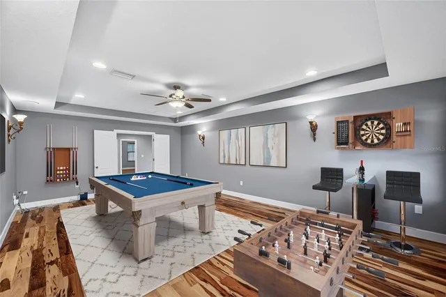 a dining room with wooden floor and furniture