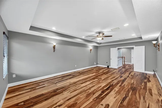 a bedroom with a large bed and a chandelier