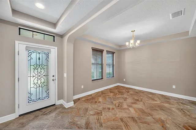 an empty room with windows and outdoor view