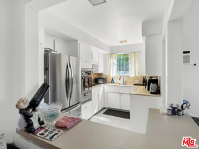 a kitchen with a sink appliances and cabinets