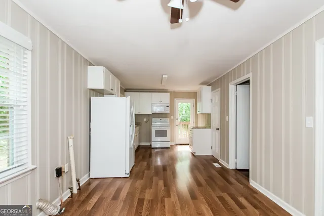 a view of kitchen with furniture and wooden floor