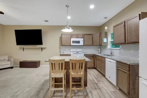 a kitchen with a sink cabinets and wooden floor