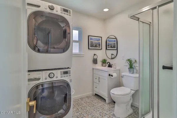 a spacious bathroom with a toilet a sink and mirror