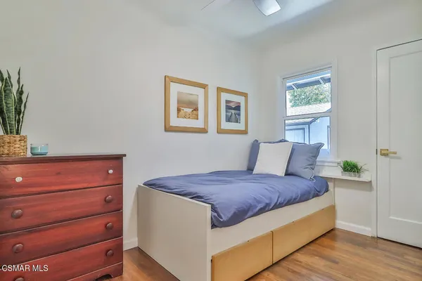 a bedroom with a bed and a dresser