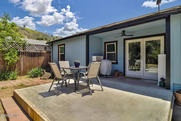 a view of a patio with a table and chairs