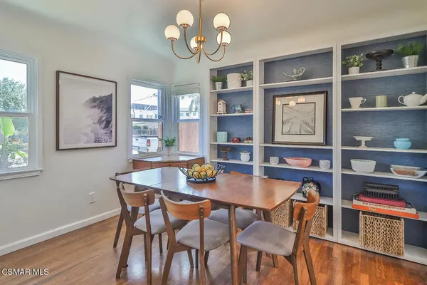 a view of a dining room with furniture and chandelier