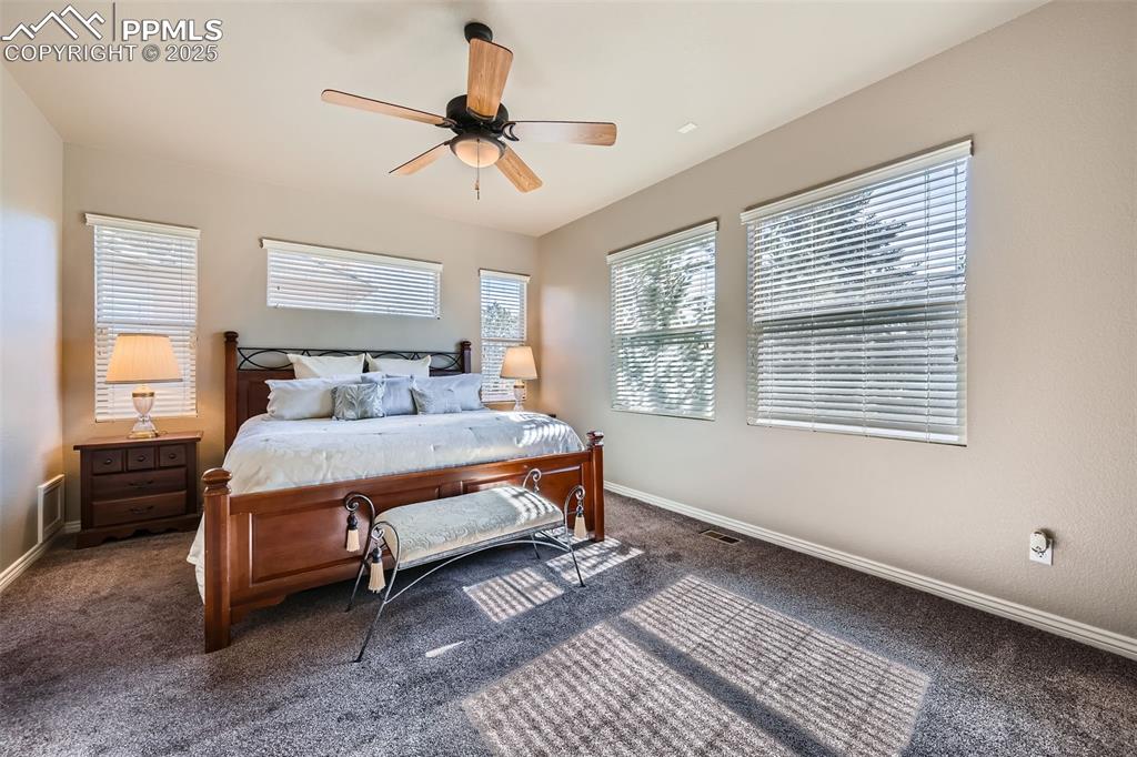 2553 Cinnabar Road Colorado Springs, CO 80921 - Photo 13 of 27 a bedroom with a bed and wooden floor