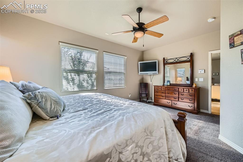 2553 Cinnabar Road Colorado Springs, CO 80921 - Photo 15 of 27 a bedroom with a bed closet and flat tv screen