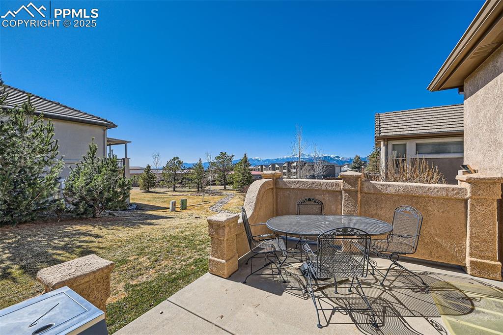 2553 Cinnabar Road Colorado Springs, CO 80921 - Photo 25 of 27 a view of a patio with table and chairs with wooden floor and fence