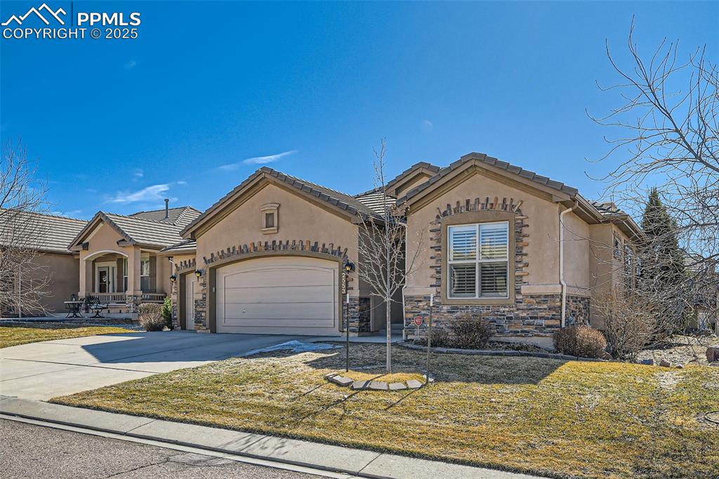2553 Cinnabar Road Colorado Springs, CO 80921 - Photo 3 of 27 a front view of a house with garden