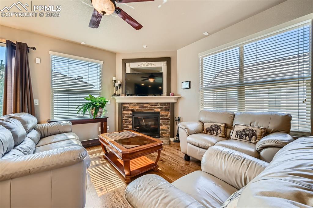 2553 Cinnabar Road Colorado Springs, CO 80921 - Photo 5 of 27 a living room with furniture a fireplace and a large window