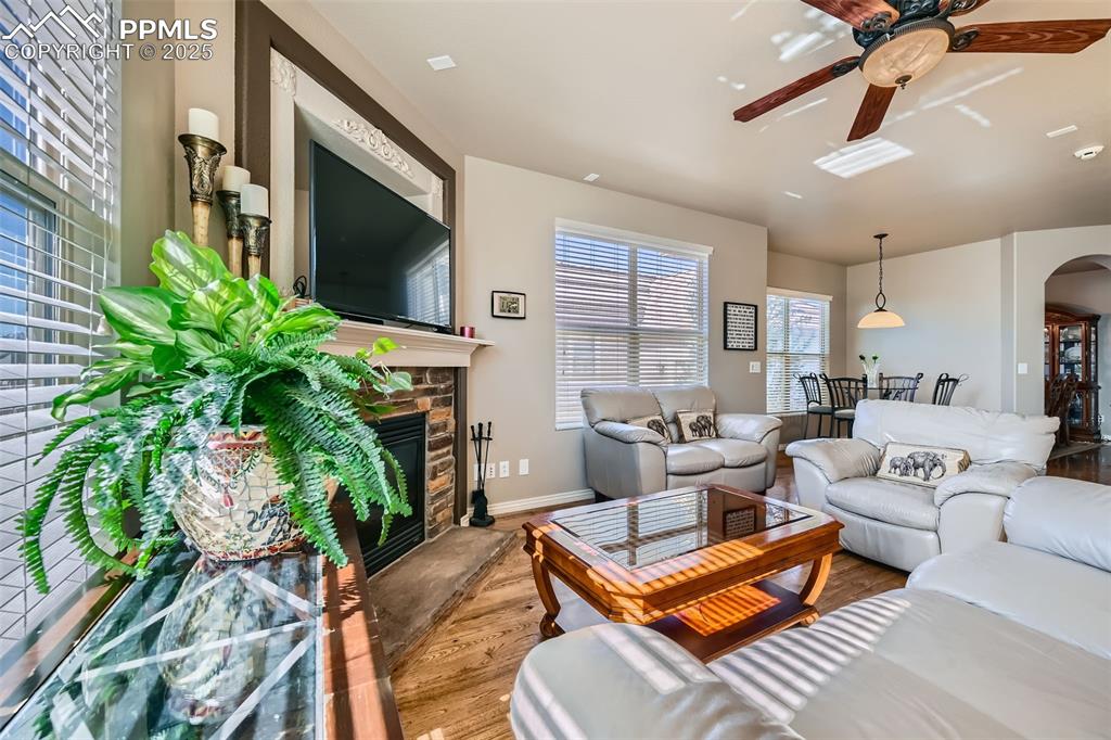 2553 Cinnabar Road Colorado Springs, CO 80921 - Photo 7 of 27 a living room with furniture a flat screen tv and a potted plant