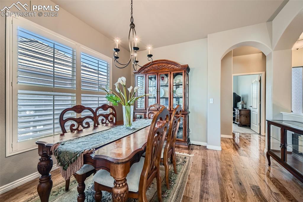 2553 Cinnabar Road Colorado Springs, CO 80921 - Photo 8 of 27 a view of a dining room with furniture wooden floor and chandelier