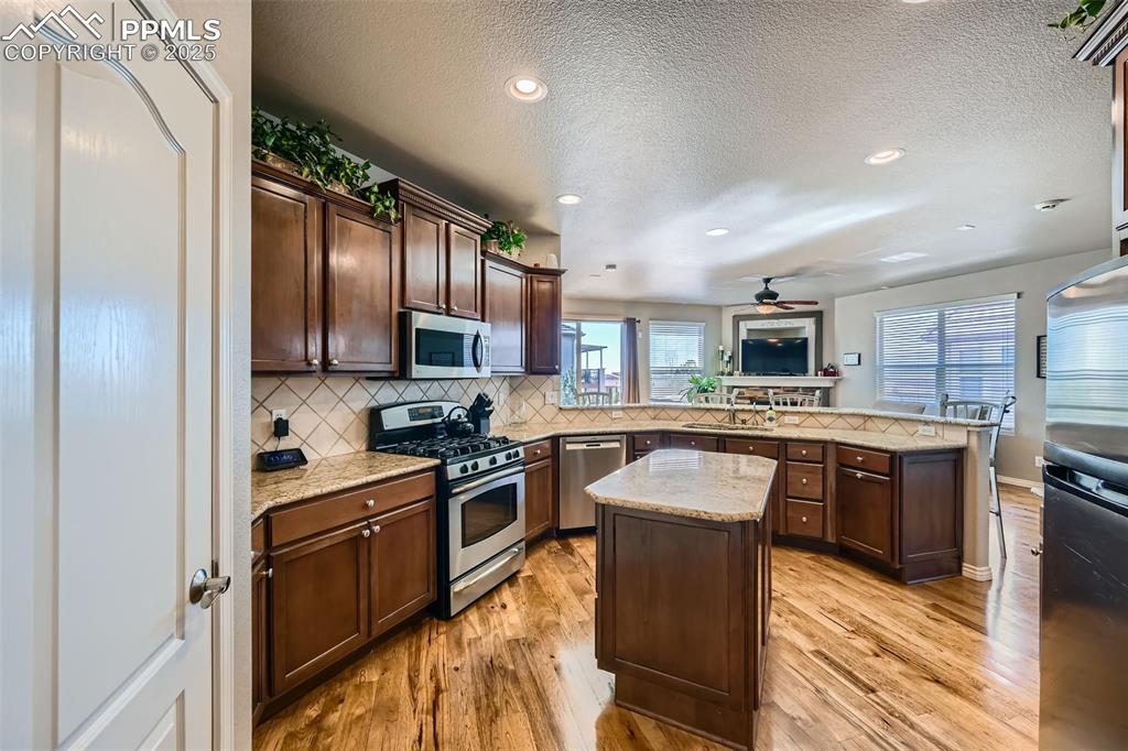 2553 Cinnabar Road Colorado Springs, CO 80921 - Photo 10 of 27 a kitchen with granite countertop stainless steel appliances and wooden cabinets