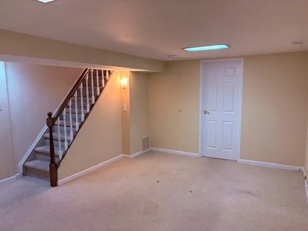 a view of an empty room with stairs