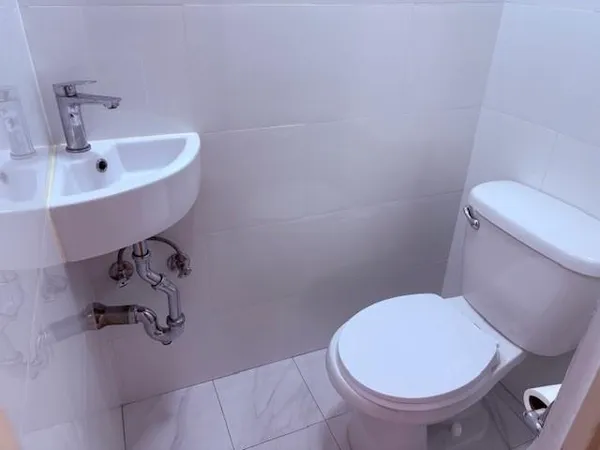 a bathroom with a sink and a chandelier fan