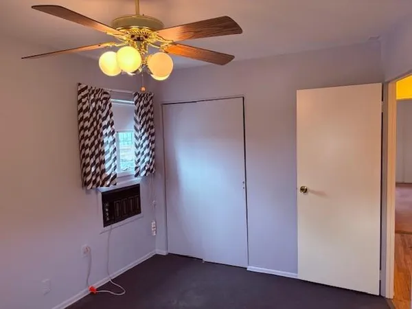 a view of a livingroom with wooden floor and cabinets
