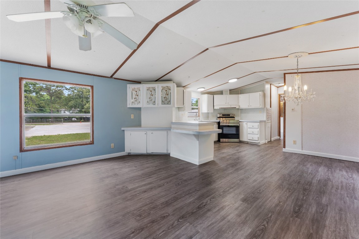 a large kitchen with cabinets and stainless steel appliances