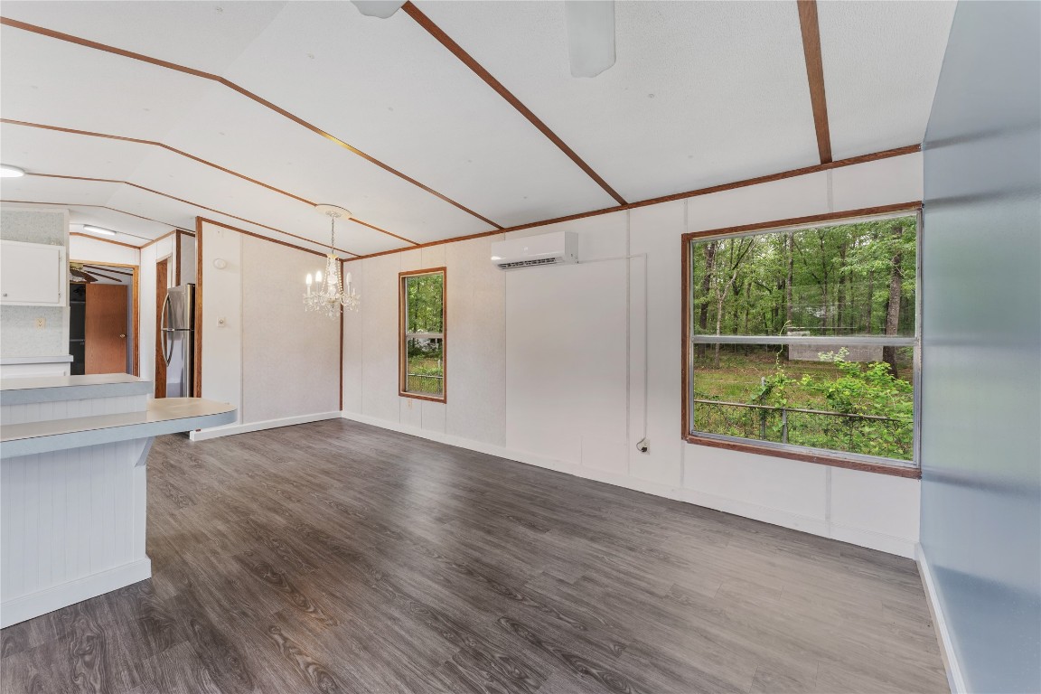 21504 Mexican John Road, Unit C New Caney, TX 77357 - Photo 13 of 15 a view of a big room with wooden floor and windows