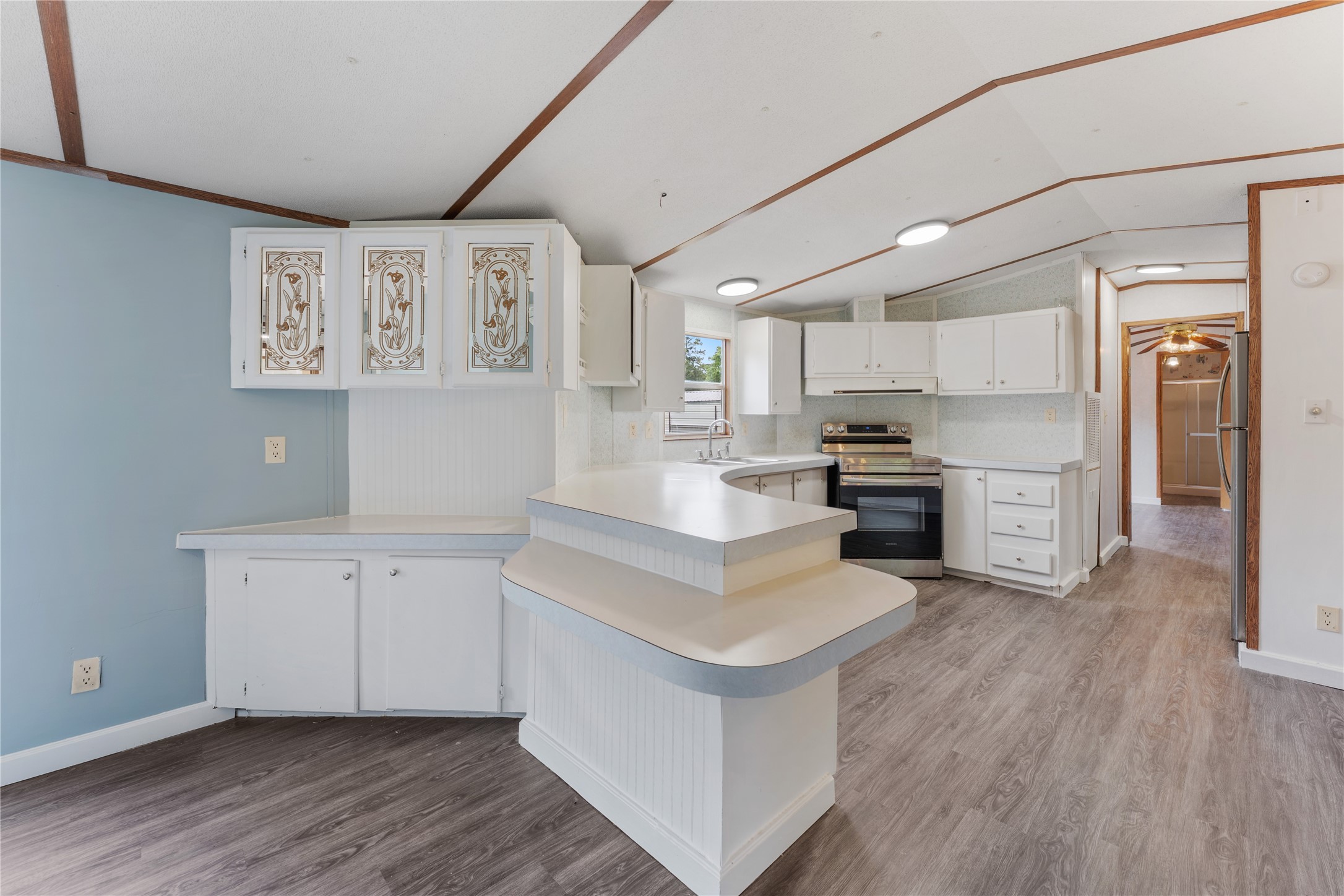21504 Mexican John Road, Unit C New Caney, TX 77357 - Photo 2 of 15 a kitchen with stainless steel appliances granite countertop a stove a sink and a refrigerator