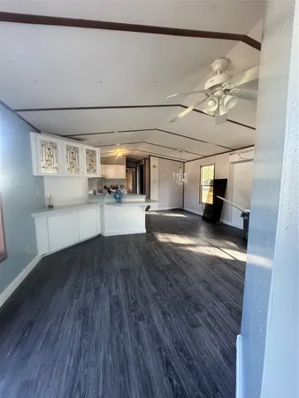 a kitchen with a wooden floor and breakfast area